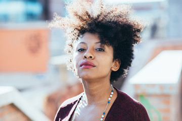 Portrait of young beautiful afro black woman looking at camera resolute - determination, resolved,...