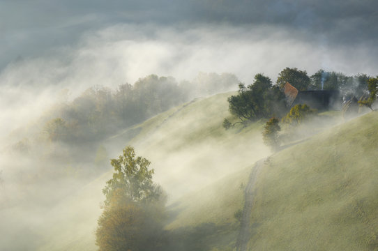 Rural landscape covered in light mist, near Zarnesti, Transylvania, Southern Carpathian Mountains, Romania, October 2008