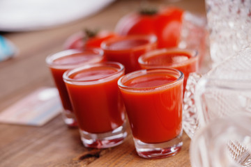 Glasses of fresh tomato juice and tomatoes 