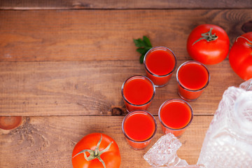 Glasses of fresh tomato juice and tomatoes 
