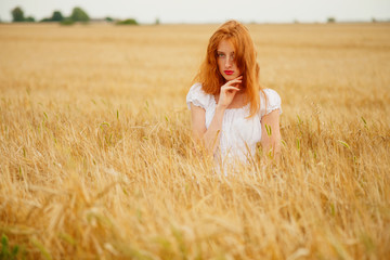 Beautiful redhead girl at meadow 