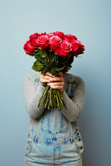 Girl with bouquet of flowers in her hands. Flowers, Spring, Romance, March 8. Women's hands are holding a bouquet of roses