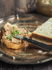 Sandwich with homemade chicken liver pate on a vintage metal plate
