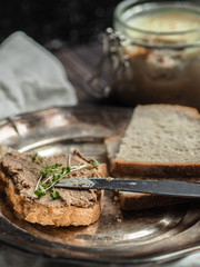 Sandwich with homemade chicken liver pate on a vintage metal plate
