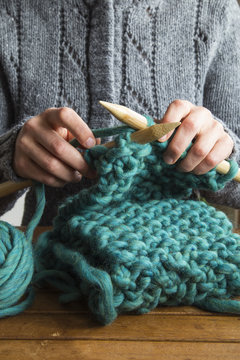 Knitting with green wool