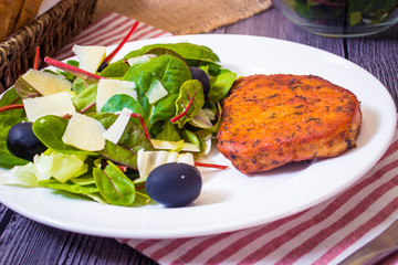 Pork steak with salad. Spinach, red valerian and chard salad