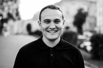 Black and white brutal portrait of a fashionable man outdoor in the city