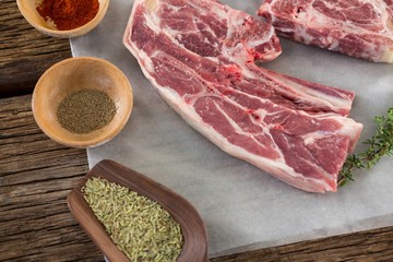 Sirloin steak and ingredients against wooden background