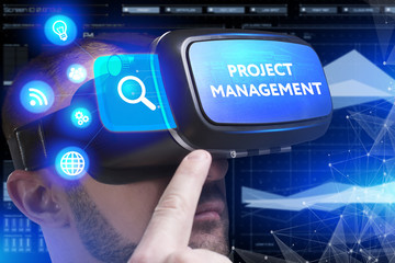 Business, Technology, Internet and network concept. Young businessman working in virtual reality glasses sees the inscription: Project management