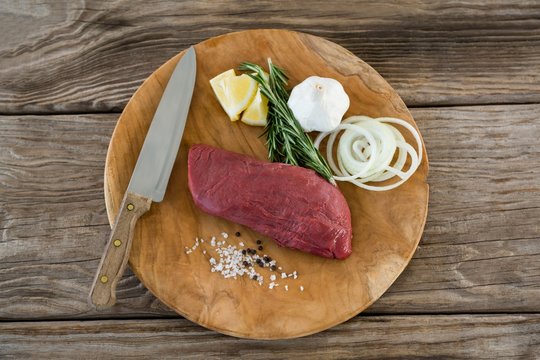 Beef steak and ingredients on wooden tray