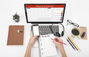 business hand typing on a laptop keyboard with Calender Planner homepage on the computer screen. organization management remind concept.