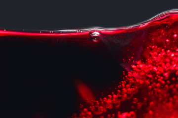 Abstract splashes of red wine on a black background
