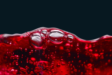 Abstract splashes of red wine on a black background