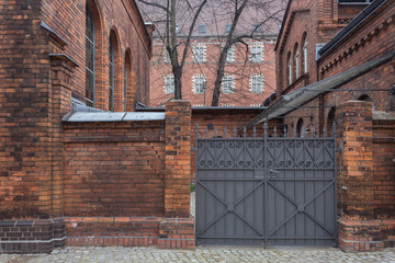 Old Red Brick Buildings with Metal Gates