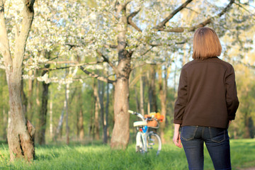 place for holding rest day/ man in jeans standing on the background of the spring landscape in the...