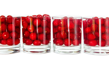 Row from glasses with fresh red cherry.Isolated on the white background