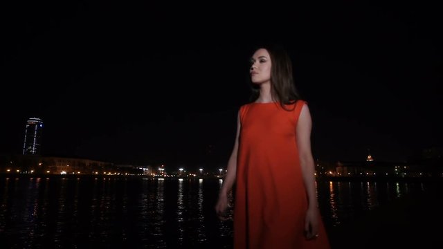 The girl in a red dress walking