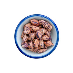 Raw Organic Pinto beans in bowl on white. This has clipping path.