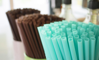 Drinks straws in container in cafe