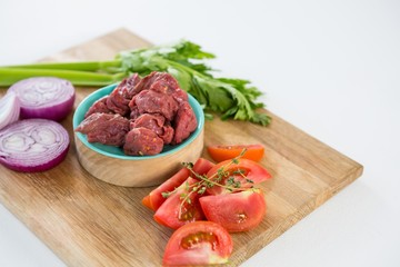 Minced beef and ingredients on wooden tray