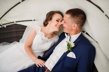 Charming wedding couple sitting in a bungalow.