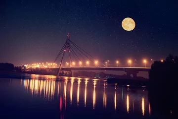 Fotobehang Moscow bridge in Kiev at night with colorful illumination and reflection in Dnieper river and big moon © Roxana