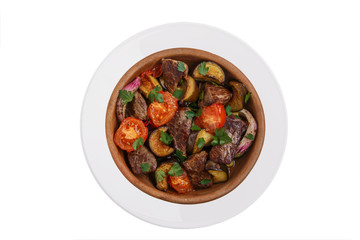 roast meat with vegetables traditional Georgian dish white background top view