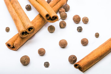 Cinnamon sticks. Allspice. Spices on a white background. Seasonings.