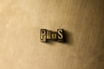 PLUS - close-up of grungy vintage typeset word on metal backdrop. Royalty free stock illustration.  Can be used for online banner ads and direct mail.