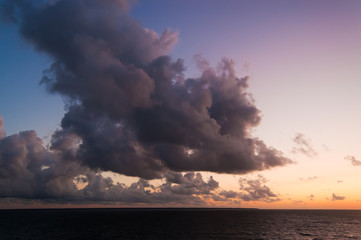 Dark  clouds in sky over Baltic sea (in Gulf of Finland) at sunset.