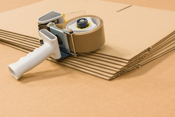 Industrial single wall corrugated cardboard Boxes and tape gun or dispenser