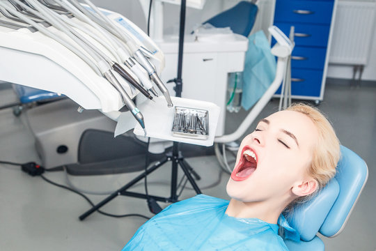girl with an open mouth waiting for examination at the dentist