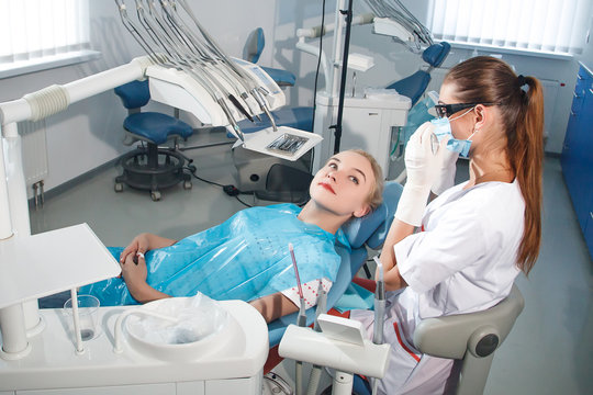 The dentist examines a patient in the dental office