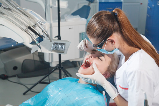 The dentist examines a patient in the dental office