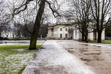 Summer Royal Palace Lazienki during winter thaws. City of Warsaw, Poland. Details of the fasade of a palace in the style of classicism.