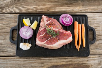 Sirloin chop and ingredients on grill tray