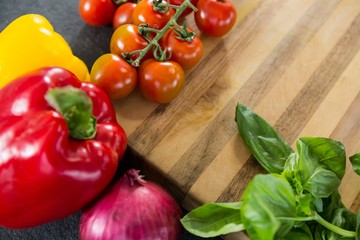 Wooden and vegetables against black background
