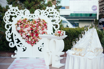 Dish with champagne and wine glasses. On outdoor wedding reception in summer.