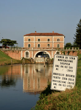 Building bridge reflected on the River Brenta, Venice, Italy