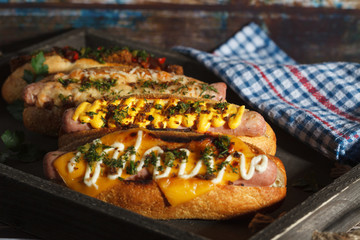 Four different hot dogs on a serving tray