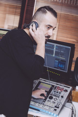 Obraz na płótnie Canvas recording operator with headphones mixing some tracks