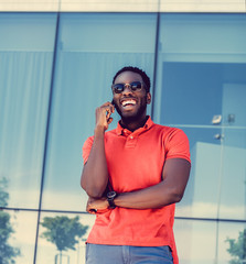 Smiling Black male dressed in a red polo shirt.