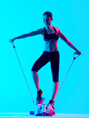 one mixed races woman exercsing Stepper fitness exercices isolated on blue blackground