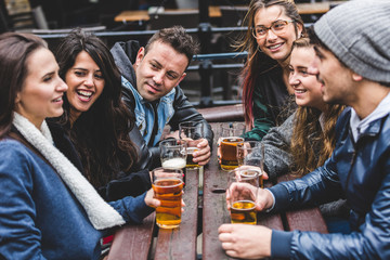 Group of friends enjoying a beer at pub in London