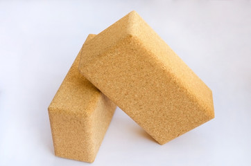 Yoga accessories. Two cork blocks on white background.