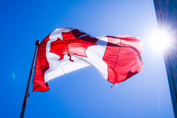 Canadian flag with blue sky as background