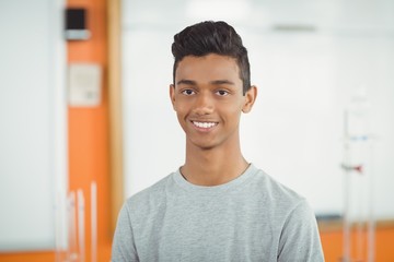 Obraz premium Portrait of smiling schoolboy in classroom