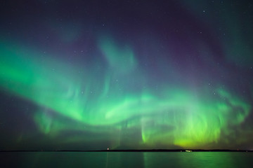 Northern lights over lake in finland