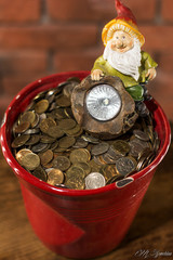 cute and happy leprechaun sitting with a pot full of gold