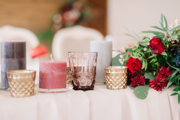 Beautifully composition of candles andred flowers